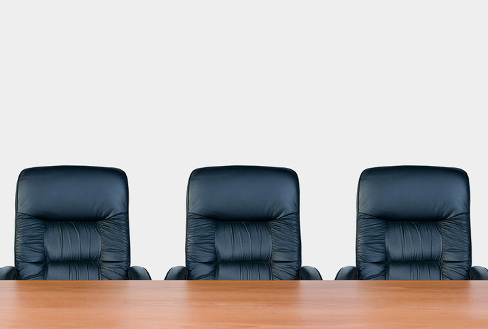 Image of three chairs behind a desk - image licensed by Ingram image