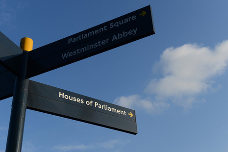 Pavement signpost showing Parliament Square, Westminster Abbey and Houses of Parliament.