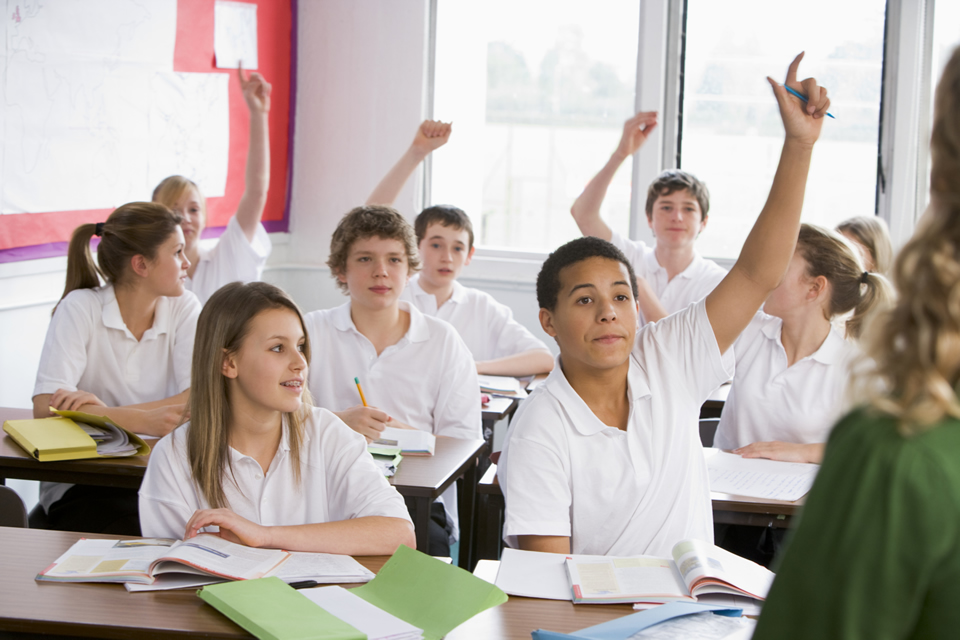 school children with textbooks in classroom