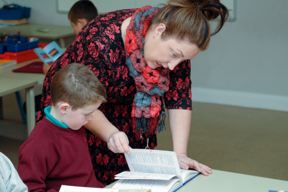 Primary teacher with pupil