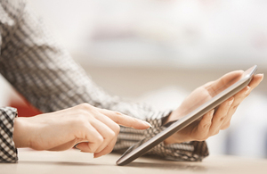 A woman using a tablet.