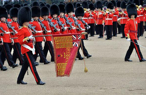 Grenadier guards marching with a flag