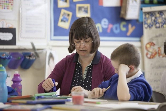 Adult and pupil working together.