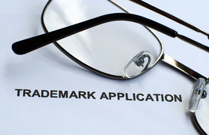 Trade mark word written on paper with glasses.