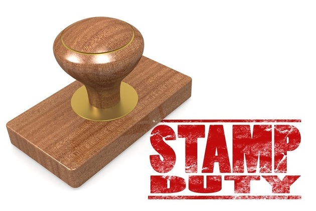 A wooden stamp with the words stamp duty written in red