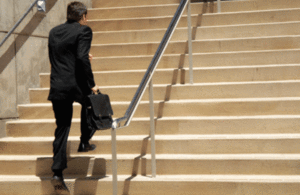 A man bounding up a set of steps.
