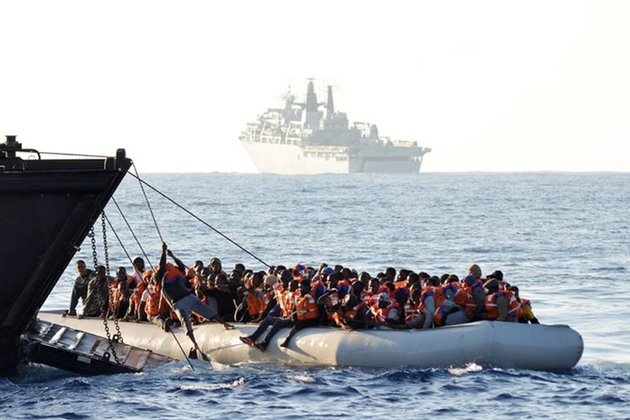 People are rescued from an inflatable boat by the Royal Navy in the central Mediterranean, June 2017. Picture: Royal Navy/ET WE CIS Louise George