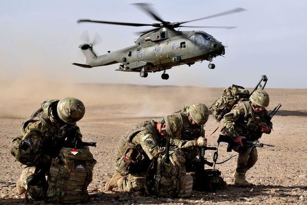 Members of II Squadron, RAF Regiment, Force Protection for Camp Bastion, Afghanistan are pictured as an RAF Merlin Helicopter arrives. Crown Copyright. Photo: via MOD.
