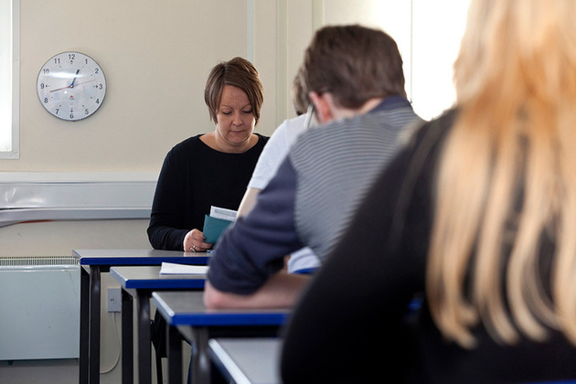 Students and teacher in an exam room