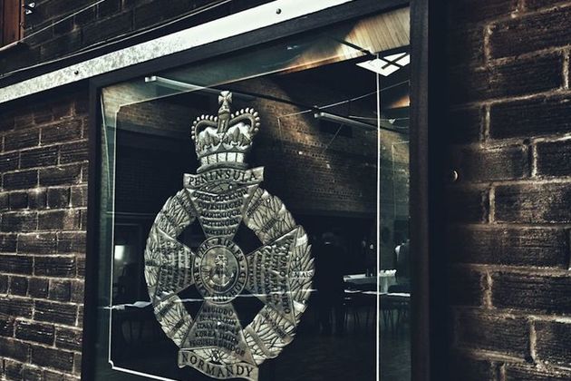 Photo of a picture frame containing a military badge. Photo: Michael Potts. All rights reserved.