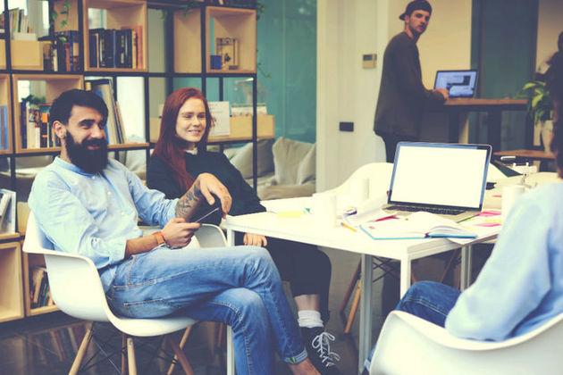 Group of young professionals working across a table
