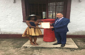 Noela Lyonga receives Commonwealth Points of Light certificate from British High Commissioner to Cameroon, H.E. Rowan Laxton.