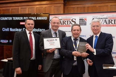 Supt Bell and Eugene Johnson receive the award on behalf of the CNC