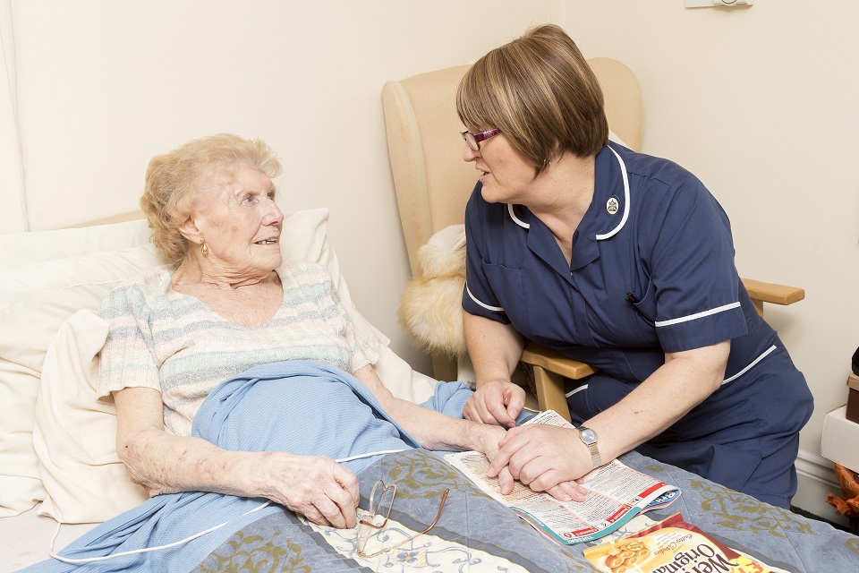nurse speaking to elderly woman