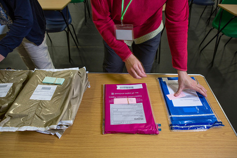 Teachers opening packs of exam papers