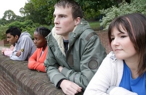 Group of young people leaning against a wall