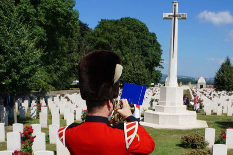 During the service a bugler plays in front of the cross. Crown Copyright. All rights reserved
