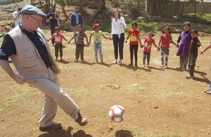 Minister Burt playing football with refugee kids in the Bekaa