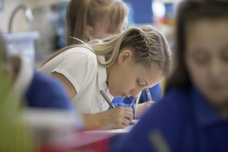 Female pupil writing.