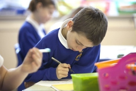 Male pupil writing.