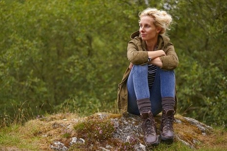 A woman in the countryside via Ben Queenborough at Shutterstock