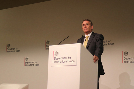International Trade Secretary Dr Liam Fox MP speaking at a podium.