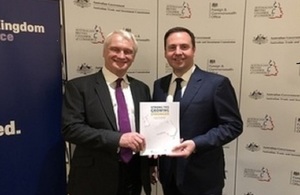 Graham Stuart and Steven Ciobo hold a copy of the UK-Australia investment report.