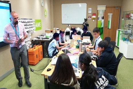 Picture of students using ScienceScope technology to learn about the Internet of things in on-site lab.
