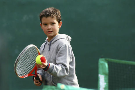 boy playing tennis