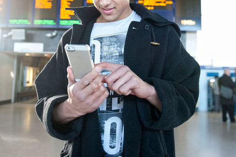 Person using phone at rail station