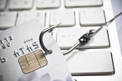 Illustration of phishing email: keyboard and fishing hook in credit card