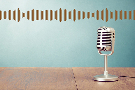 Microphone on stand with sound waves.