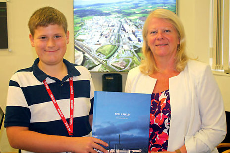 Samuel Boardman being presented with a Sellafield Ltd book