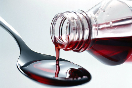 medicine being poured onto a spoon