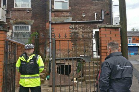Police officer and MHRA staff member outside house