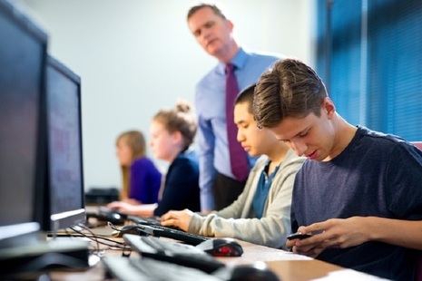 boy texting in classroom