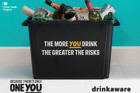Plastic box containing lots of empty bottles, featuring the message 'the more you drink, the greater the risks'.