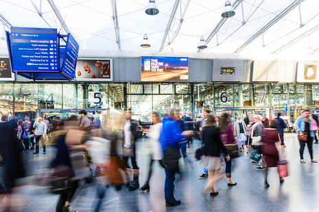 Picture of rail pasengers at a station.
