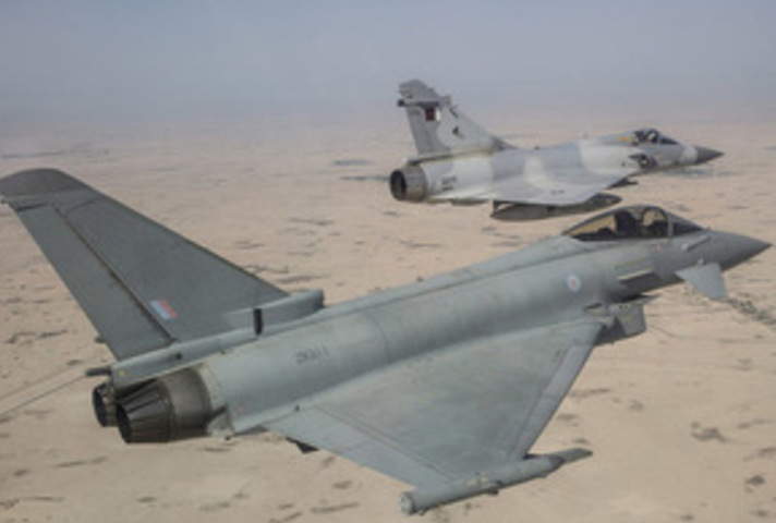 RAF Typhoon (foreground) and a QEAF Mirage jet taking part in a joint exercise held by the Emir of Qatar's Air Force.