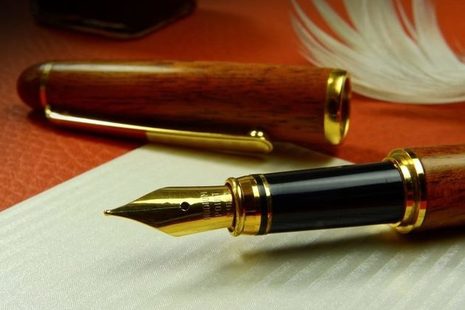 Pen quill and paper
