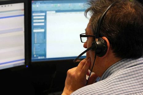 Office worker looking at computer screens