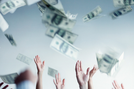 Hands throwing money in the air