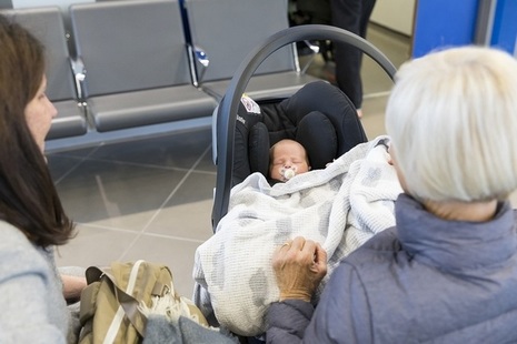 Baby in car seat at GP waiting area.