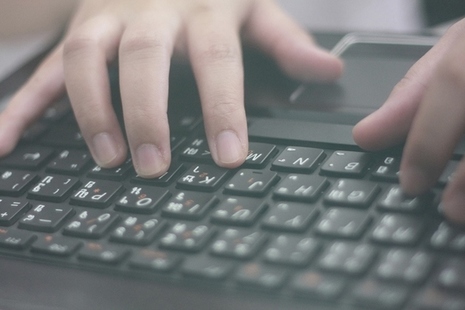 Hands typing on a keyboard