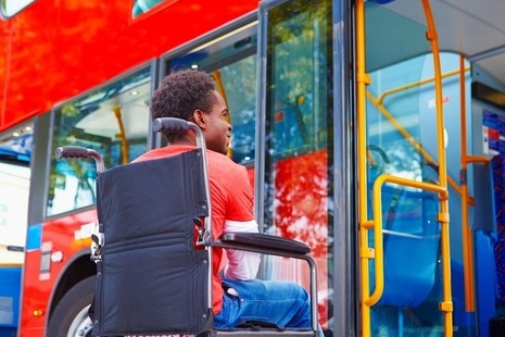 A wheelchair user boards a bus