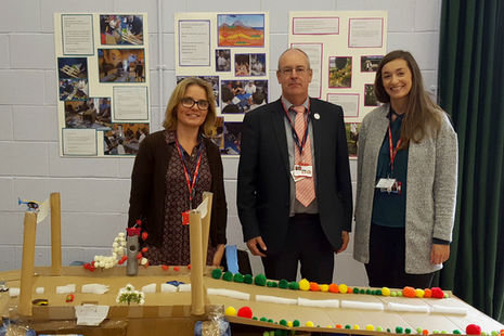 Minety School teacher Maria Madeley, left, with Garry Packer and Emma Grayson of Highways England and her pupils' bridge design at the British Science Association's How Real Stuff Works event at Malmesbury School