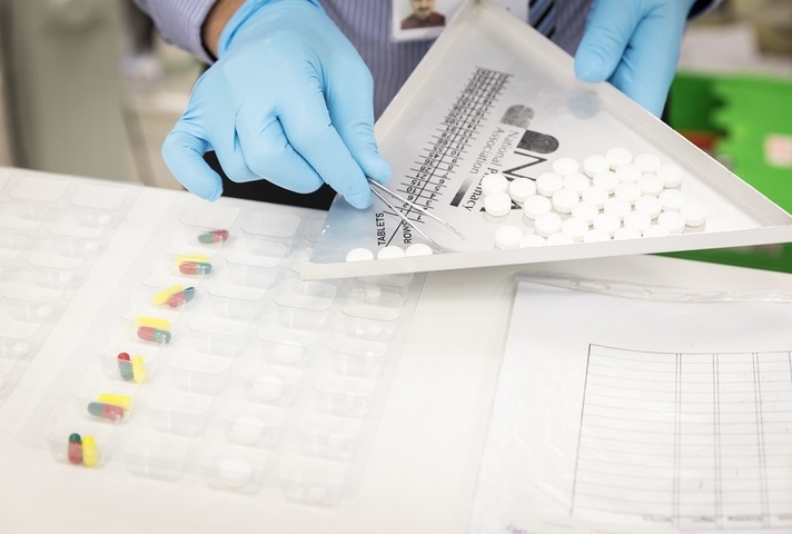 Pharmacist measuring out prescription.