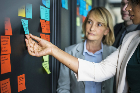 Woman touching blue post-it note