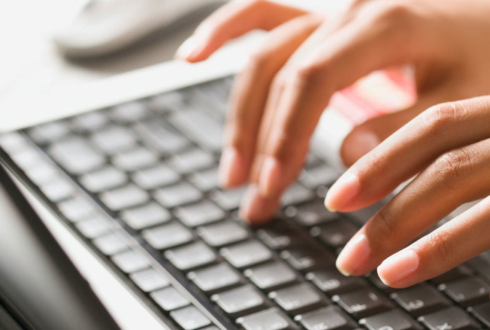 Fingers typing on keyboard