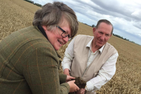 Environment Minister Thérèse Coffey holding soil sample.